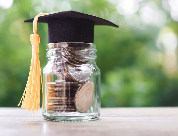 Jar of change topped with graduation cap